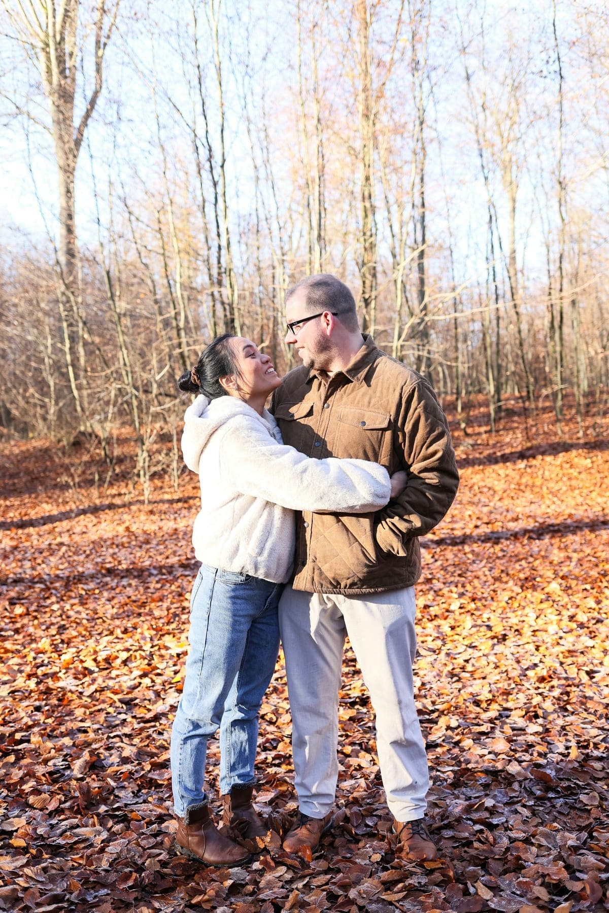 Couple embracing among autumn trees