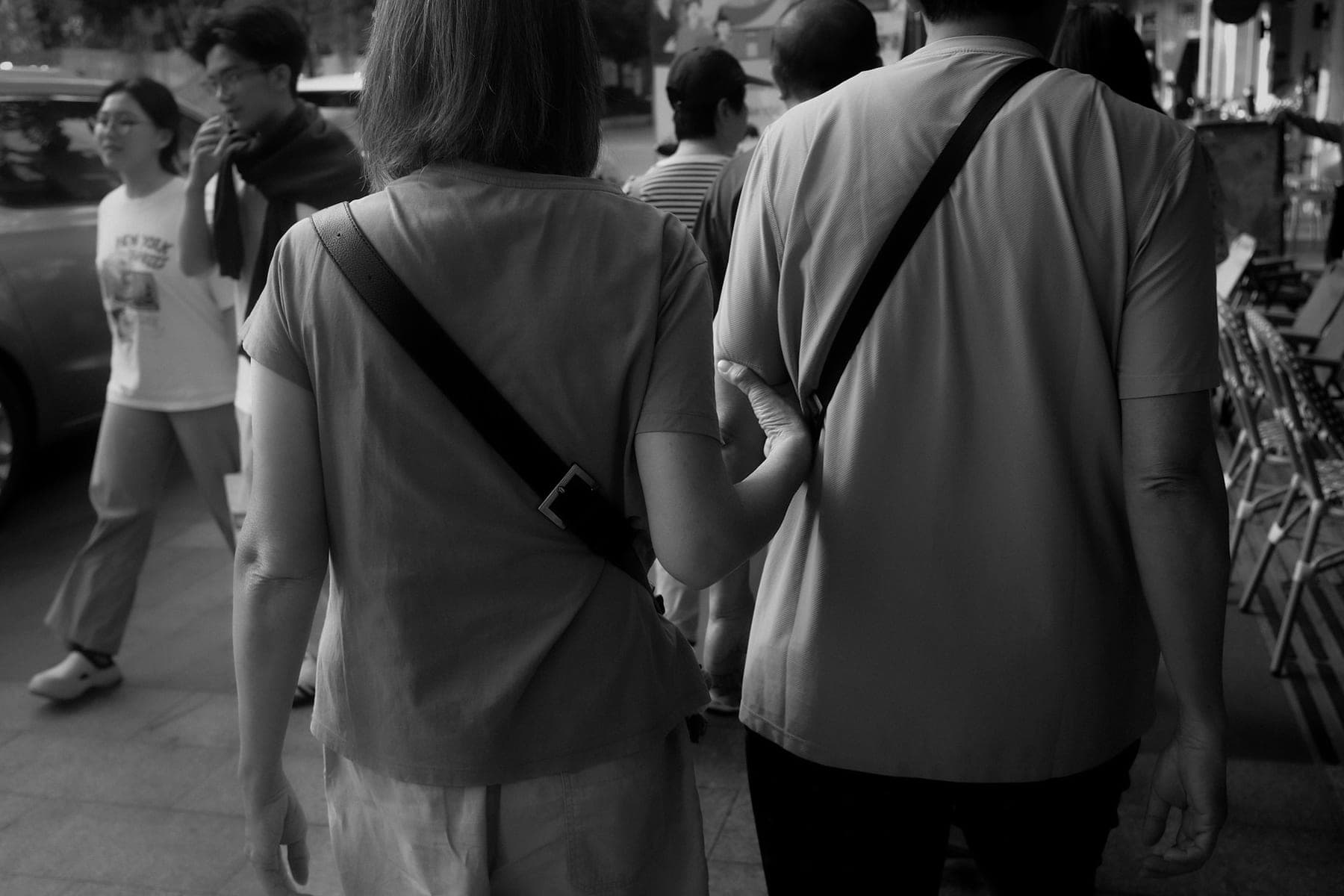 Two people walking together on a city street