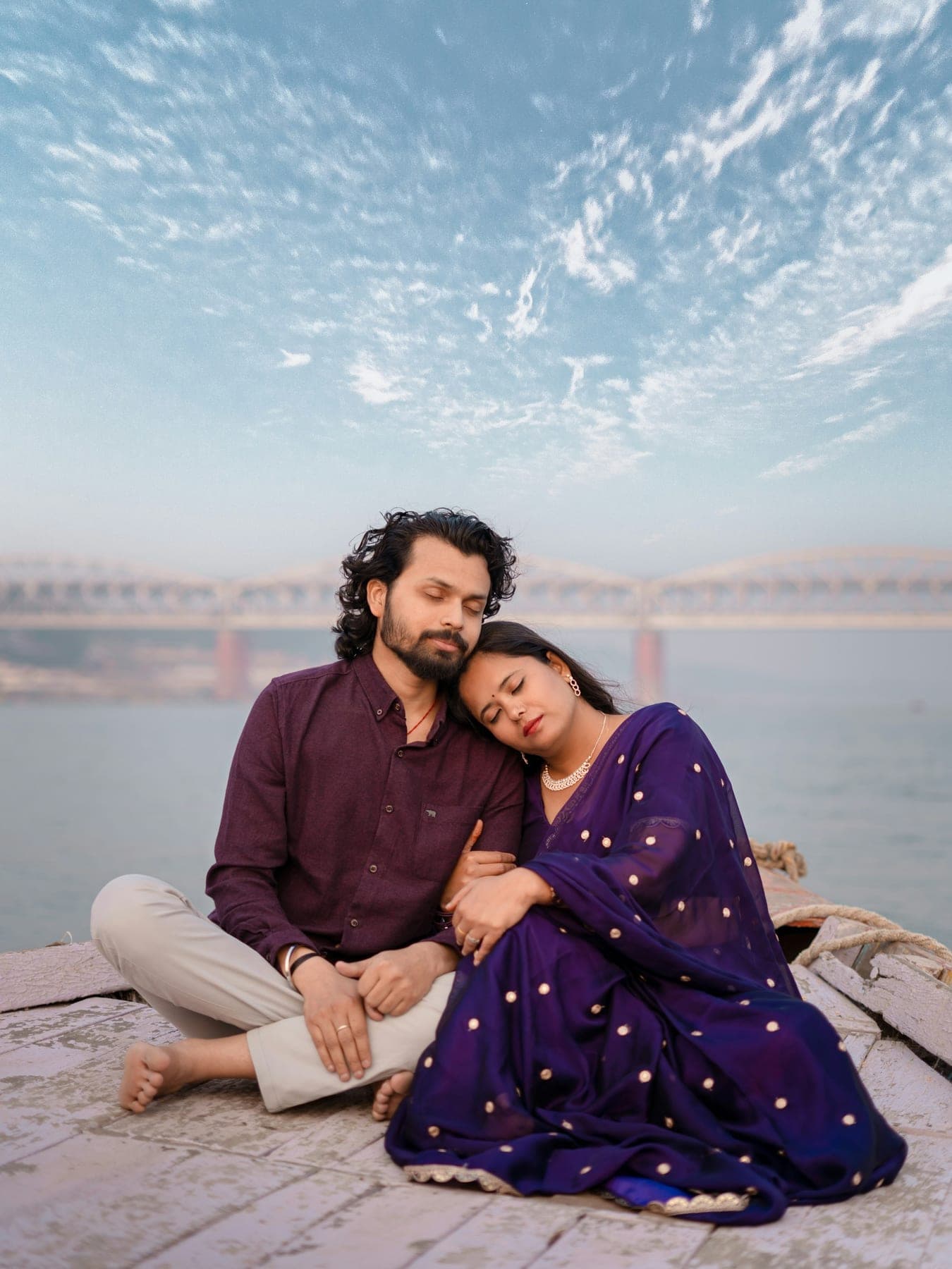 Couple sitting together by the water